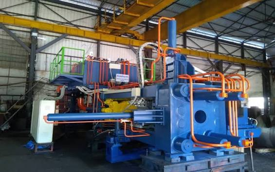 Blue aluminium extrusion press inside a manufacturing plant
